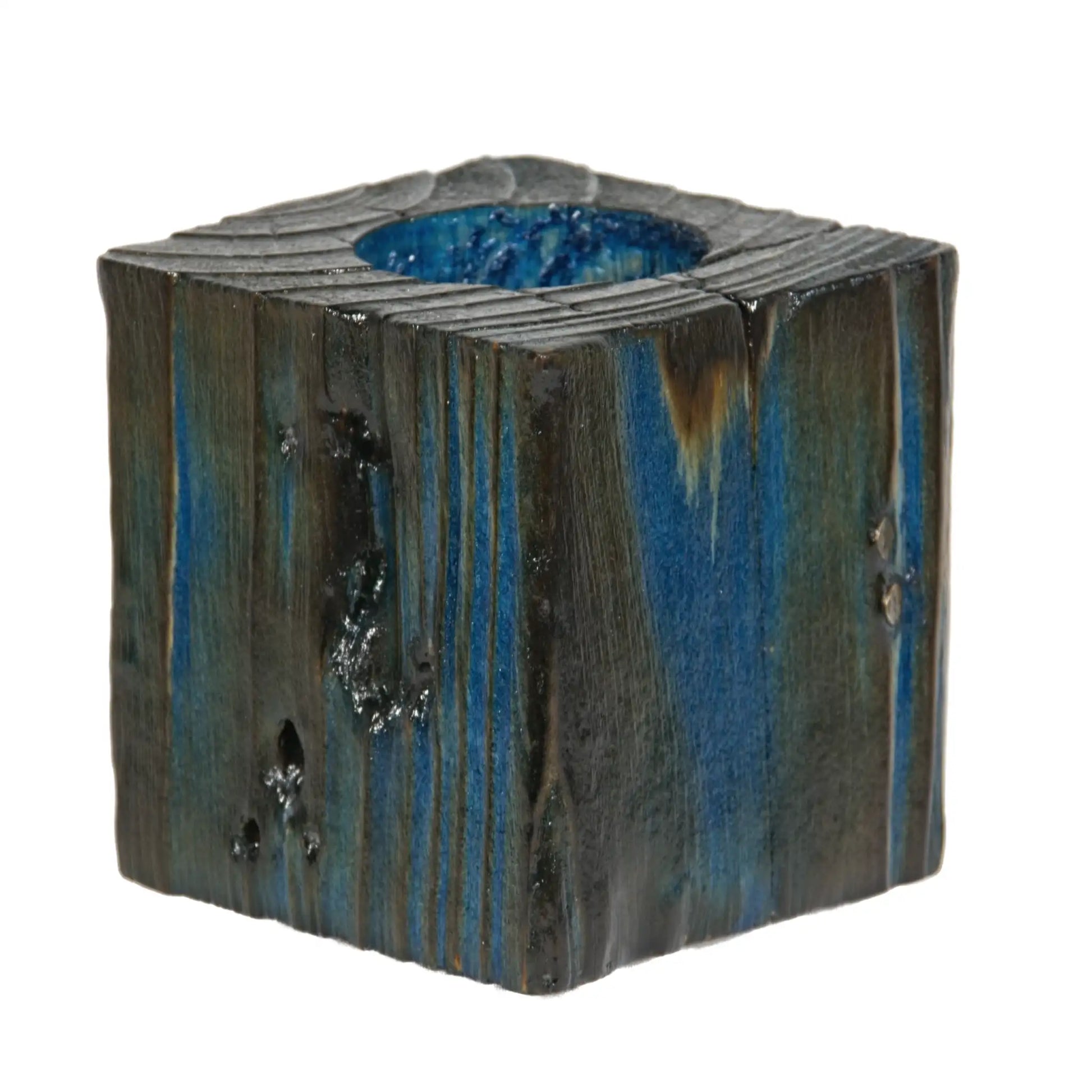 A handcrafted wooden fence post tealight holder, 70mm high and finished in a blue colour. Shown on a white background.