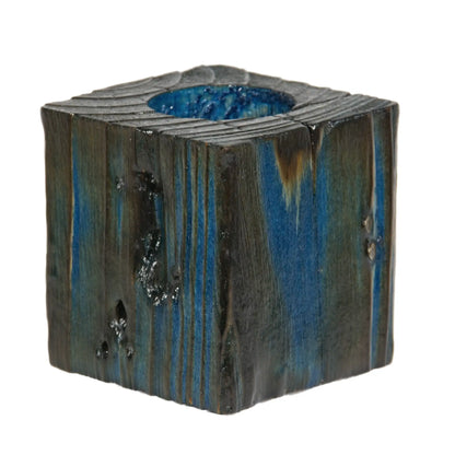A handcrafted wooden fence post tealight holder, 70mm high and finished in a blue colour. Shown on a white background.