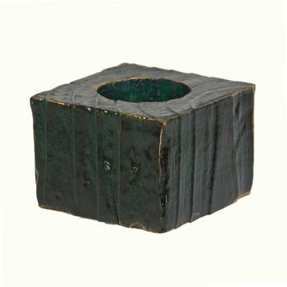 A handcrafted wooden Christmas fence post tealight holder, 50mm high and finished in green, with flashes of gold gilding paste. Shown on a white background.
