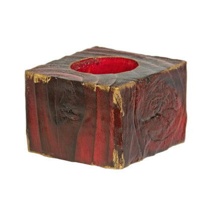 A handcrafted wooden Christmas fence post tealight holder, 50mm high and finished in red, with flashes of gold gilding paste. Shown on a white background.