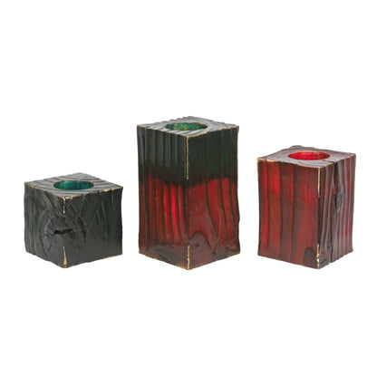 A set of 3 wooden Christmas tealight holders of different sizes. The largest has a green top. Shown on a white background. 