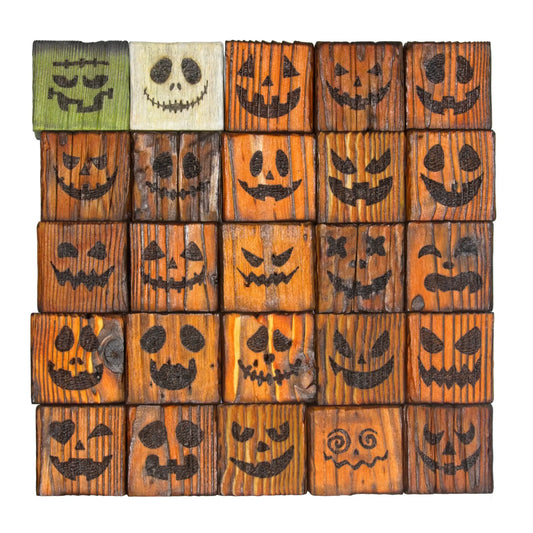 Twenty five stacked handcrafted tealight holders, with images of different pumpkin faces on the front. Shown on a white background.