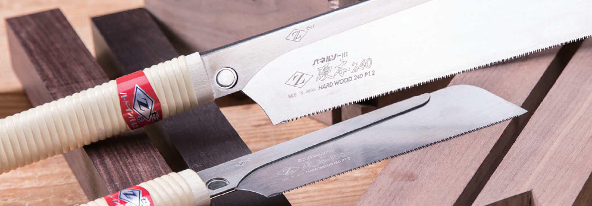 Image showing two Zetsaw Japanese Saws. Shown on a background of varying hardwood blocks.